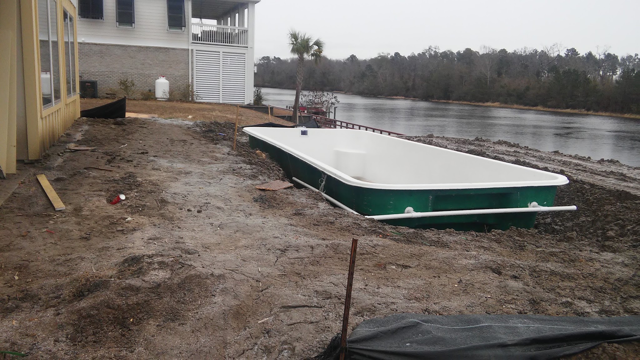 Pool shell on a lakeside lot
